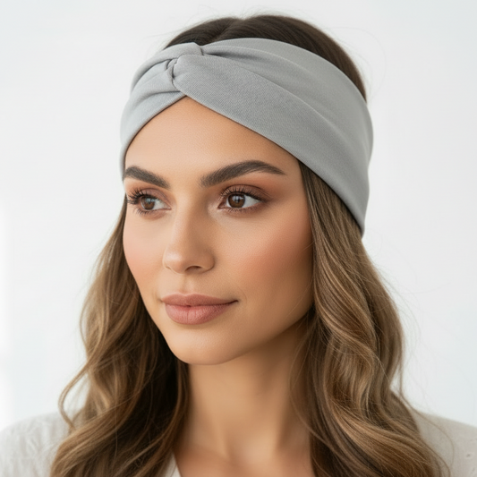 Woman wearing a gray headband against a white background