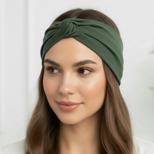 Woman wearing a green headband against a white background